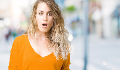 Beautiful young blonde woman over isolated background afraid and shocked with surprise expression, fear and excited face.
