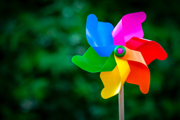 Colorful pinwheel against green background