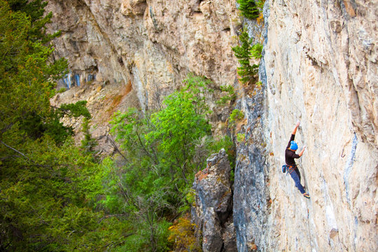 A man warms up the digits on  the Porcelain Wall (5.11c) at Natural Bridge State Park.