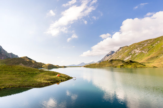 Allg&permil;u, Bavaria, Germany: A male backpacker plunging into the cold water of a lake.