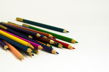 Colored pencils on white background. Office, school supplies. Artistic concept.