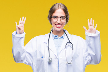 Beautiful young blonde doctor woman wearing medical uniform over isolated background showing and...