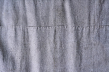 green rough fabric with pleats and seam