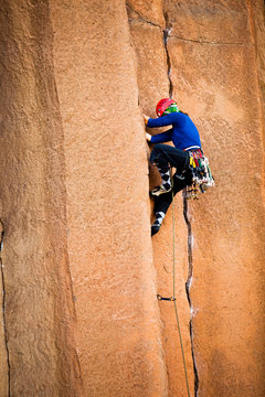 A woman climbs in argyle socks at Trout Creek in Central Oregon.