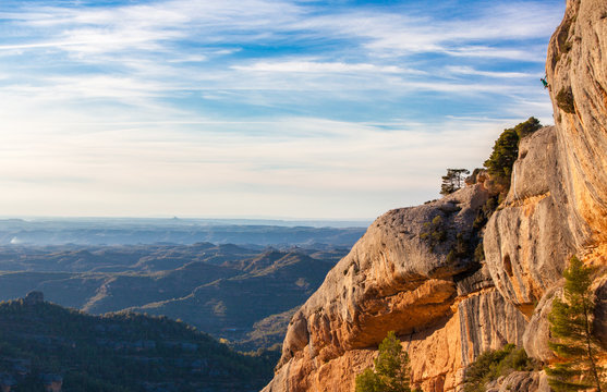 Henry Schlotzhauer tops out on Gotim bru (7b) during a blazing sunset on El balco de l'ermita sector in the Parc Natural de la Serra del Montsant near Margalef, Spain.