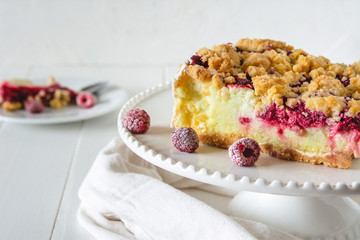 Shortcrust raspberries pie with crumble on white background.