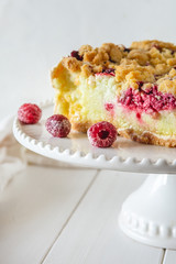 Shortcrust raspberries pie with crumble on white background.