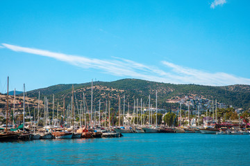 Fototapeta premium View of the Bodrum Marina, sailing boats and yachts in Bodrum town, city of Turkey. Shore and coast of Aegean Sea with yachts 