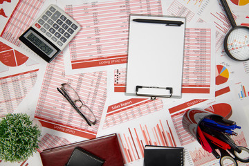 Flat top view of business workspace - reports with data, tables and analytic chart. Business...