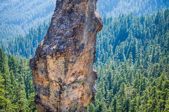 Aerial view of climber climbing on mountain cliff