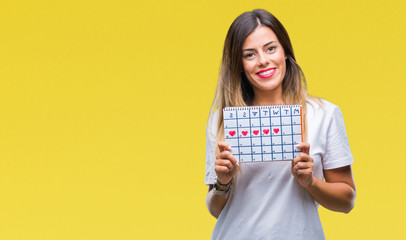 Fototapeta na wymiar Young beautiful woman holding menstruation calendar over isolated background with a happy face standing and smiling with a confident smile showing teeth
