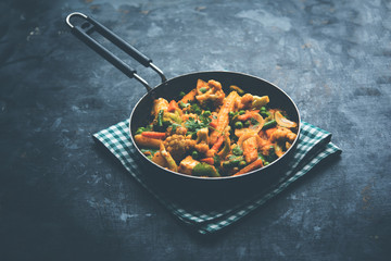 Mix vegetable curry - Indian main course recipe contains Carrots, cauliflower, green peas and beans, baby corn, capsicum and paneer/cottage cheese with traditional masala and curry, selective focus