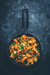 Mix vegetable curry - Indian main course recipe contains Carrots, cauliflower, green peas and beans, baby corn, capsicum and paneer/cottage cheese with traditional masala and curry, selective focus