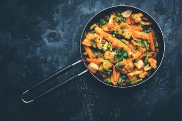 Mix vegetable curry - Indian main course recipe contains Carrots, cauliflower, green peas and beans, baby corn, capsicum and paneer/cottage cheese with traditional masala and curry, selective focus