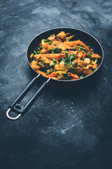 Mix vegetable curry - Indian main course recipe contains Carrots, cauliflower, green peas and beans, baby corn, capsicum and paneer/cottage cheese with traditional masala and curry, selective focus