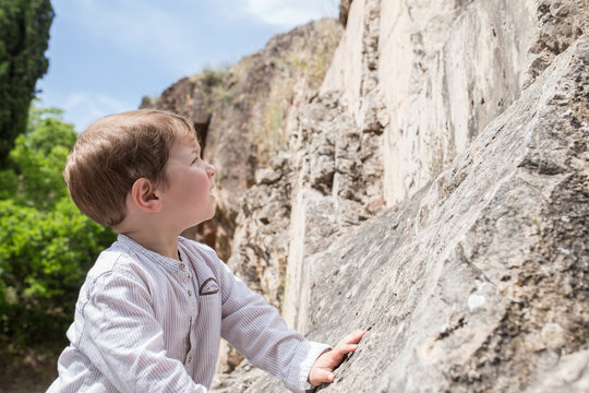 3 years old child boy climbing rock