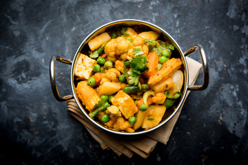 Mix vegetable curry - Indian main course recipe contains Carrots, cauliflower, green peas and beans, baby corn, capsicum and paneer/cottage cheese with traditional masala and curry, selective focus
