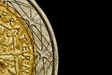 Reverse side of a coin two euro close-up isolated on black background. Detail of metallic money close up. EU money
