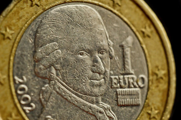 one euro coin close up isolated on black background. Detail of metallic money close up. EU money
