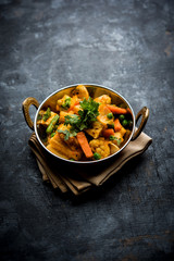 Mix vegetable curry - Indian main course recipe contains Carrots, cauliflower, green peas and beans, baby corn, capsicum and paneer/cottage cheese with traditional masala and curry, selective focus