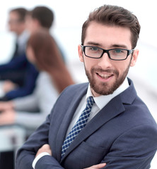 smiling businessman on background of office