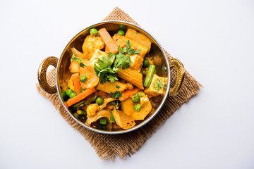 Mix vegetable curry - Indian main course recipe contains Carrots, cauliflower, green peas and beans, baby corn, capsicum and paneer/cottage cheese with traditional masala and curry, selective focus
