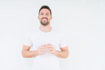 Young handsome man wearing casual white t-shirt over isolated background Hands together and fingers crossed smiling relaxed and cheerful. Success and optimistic