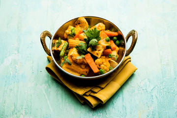 Mix vegetable curry - Indian main course recipe contains Carrots, cauliflower, green peas and beans, baby corn, capsicum and paneer/cottage cheese with traditional masala and curry, selective focus