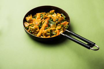 Mix vegetable curry - Indian main course recipe contains Carrots, cauliflower, green peas and beans, baby corn, capsicum and paneer/cottage cheese with traditional masala and curry, selective focus