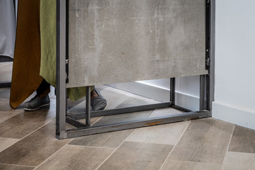 Woman's feet seen at changing room in an apparel or clothing store. 
