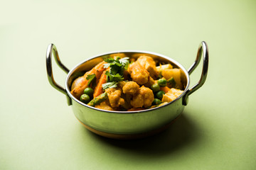 Mix vegetable curry - Indian main course recipe contains Carrots, cauliflower, green peas and beans, baby corn, capsicum and paneer/cottage cheese with traditional masala and curry, selective focus