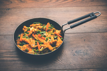 Mix vegetable curry - Indian main course recipe contains Carrots, cauliflower, green peas and beans, baby corn, capsicum and paneer/cottage cheese with traditional masala and curry, selective focus