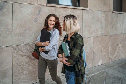 Two young students walking together in the college