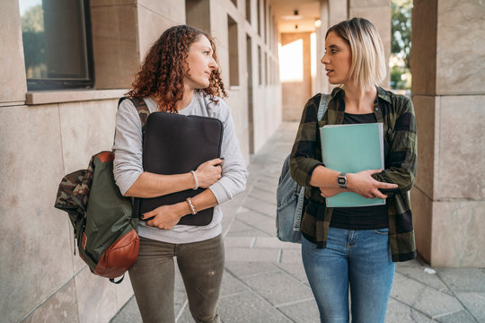 Two young students walking together in the college