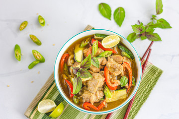 Thai Green Chicken Curry in a Bowl with Chopsticks, Garnished with Thai Basil Leaves and Lemon. Asian and Thai Food, .Oriental Cuisine Photography..