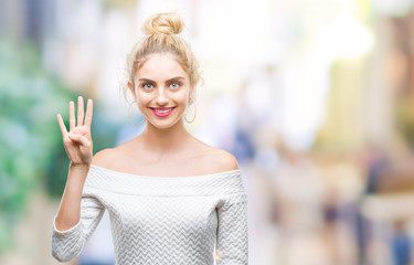 Young beautiful blonde and blue eyes woman over isolated background showing and pointing up with fingers number four while smiling confident and happy.