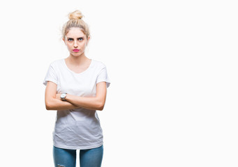 Young beautiful blonde woman wearing white t-shirt over isolated background skeptic and nervous,...