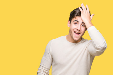 Young handsome man over isolated background surprised with hand on head for mistake, remember...