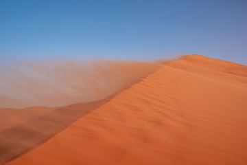 Fototapeta na wymiar Landscape view of sand dunes during the windy weather, Sahara, Morocco.