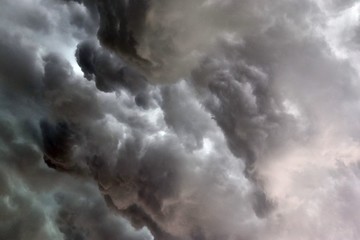 Very dark cloud formations of a heavy thunderstorm during sunset