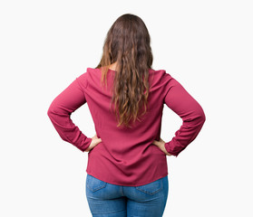 Beautiful plus size young woman over isolated background standing backwards looking away with arms...