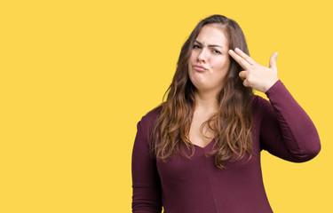 Beautiful and attractive plus size young woman wearing a dress over isolated background Shooting and killing oneself pointing hand and fingers to head, suicide gesture.