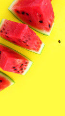 close up watermelon pieces on yellow background