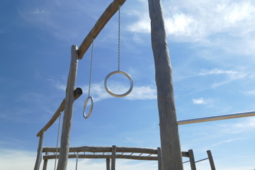 metal rings on wooden construction in children playground
