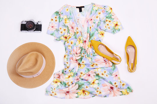 Casual clothing items snd accessories or summer symbols, beachwear on colored paper textured background with a lot of copy space for text. Top view, flat lay.