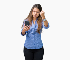 Young beautiful brunette business woman using smartphone over isolated background annoyed and frustrated shouting with anger, crazy and yelling with raised hand, anger concept