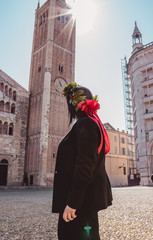 back view of a girl on her graduation day with a laurel crown in parma watching the dome