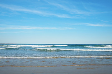 Fototapeta na wymiar Beautiful panoramic view of sandy beaches somwhere in Algarve, Portugal. Copy space for text, clean turquoise Ocean water background.