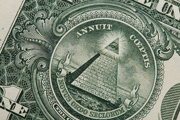 Close up of the pyramid and eye on the back of a one dollar bill