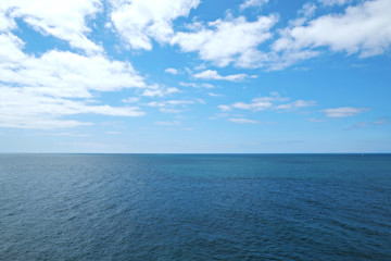 Fototapeta premium Beautiful panoramic sea view from the beach somwhere in Algarve, Portugal. Copy space for text, clean turquoise Ocean water background.